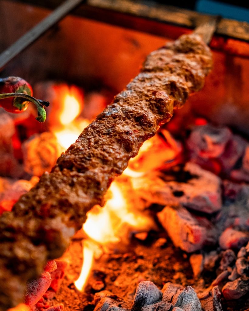 Adana Kebab is on grill, fire is small but effective to cook.