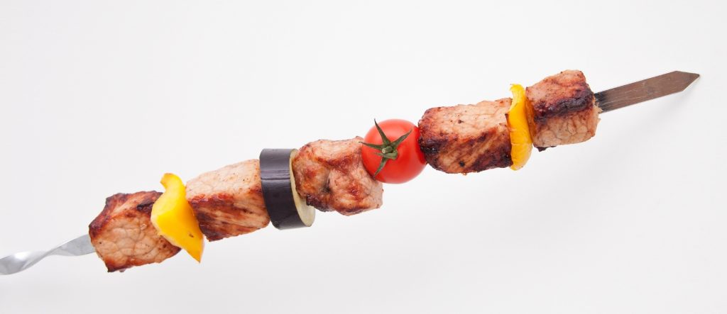 Succulent Turkish Shish Kebab with grilled lamb, bell pepper, eggplant, and cherry tomato on a skewer.