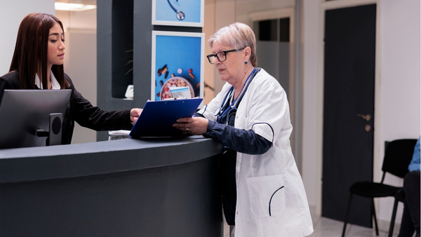 Super-Medical An international patient coordinator at a premier Turkish clinic meticulously planning a treatment schedule with a senior physician, ensuring a seamless and professionally managed healthcare journey.